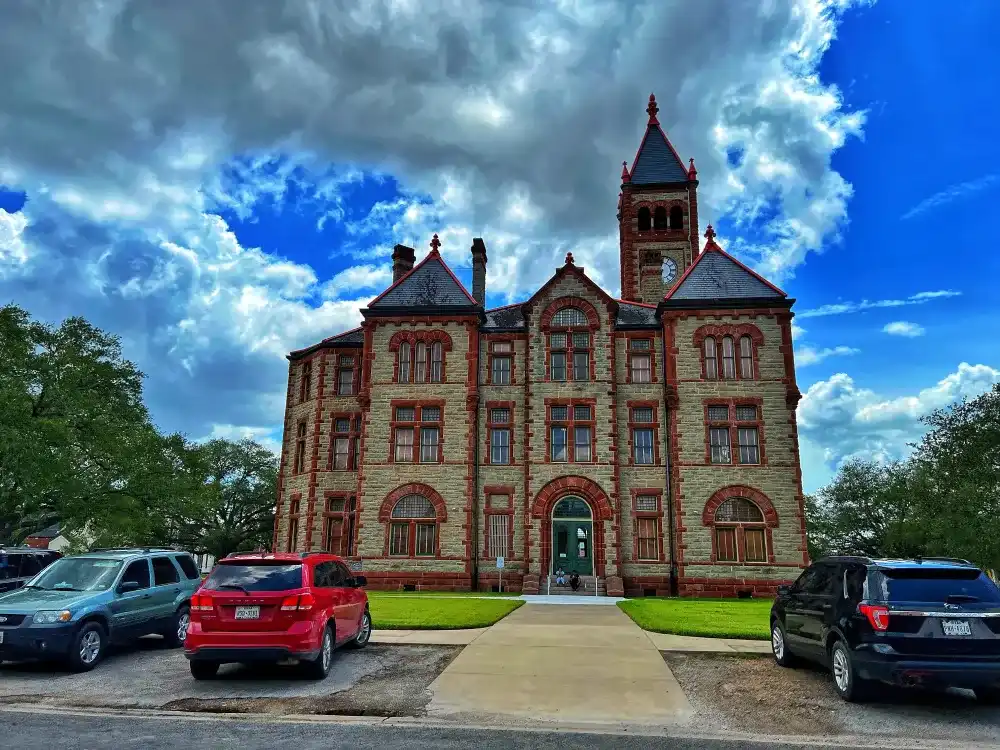 Historic Victorian courthouse with red stone trim and clock tower