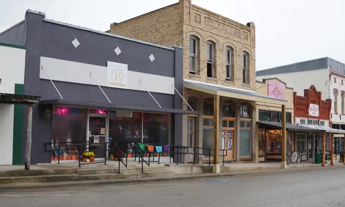 Cuero Main Street storefronts on a cloudy day.